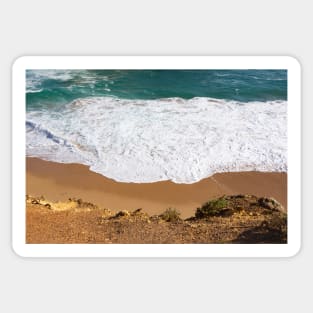 White water rolls in over orange sand at Port Campbell, Australia. Sticker